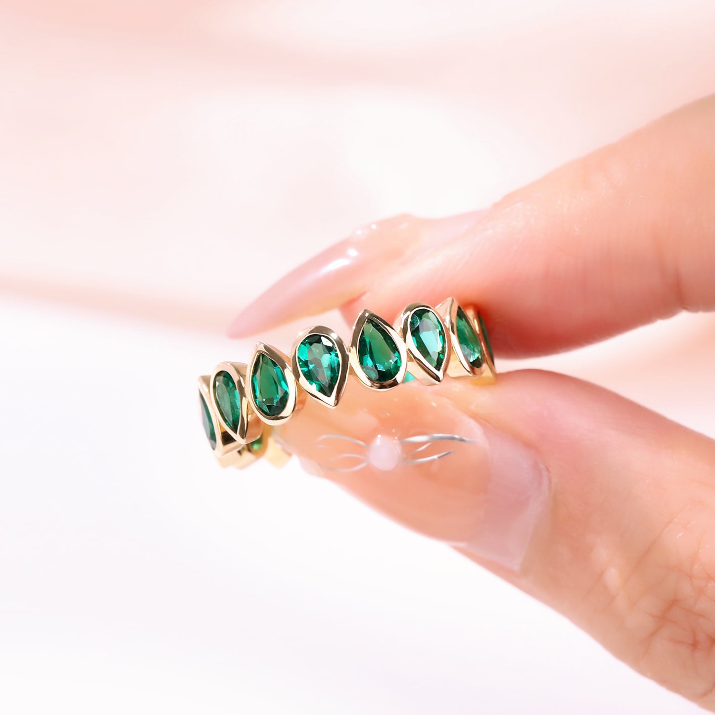 Bezel set Lab Grown Emerald 3x5 pear shaped eternity band ring in gold