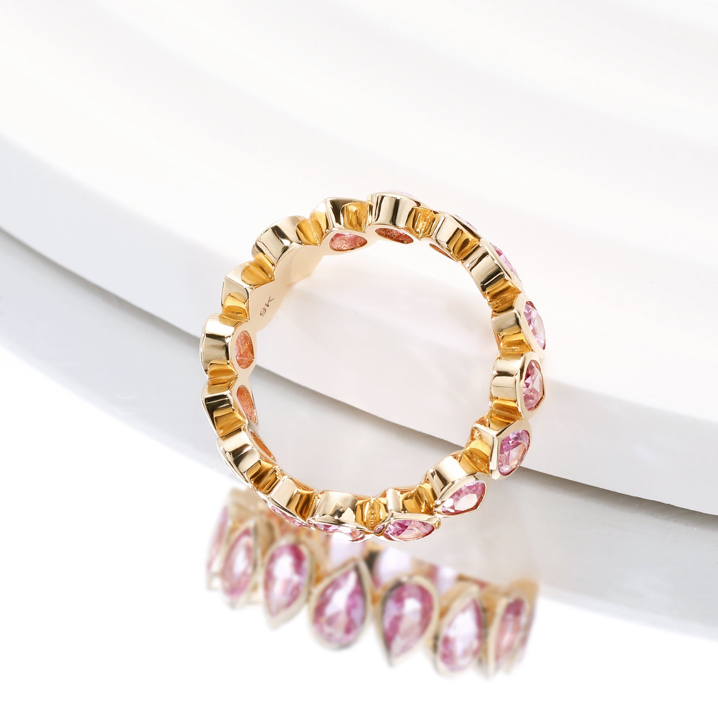 Bezel set Lab Grown Pink Sapphire 3x5 pear shaped eternity band ring in gold