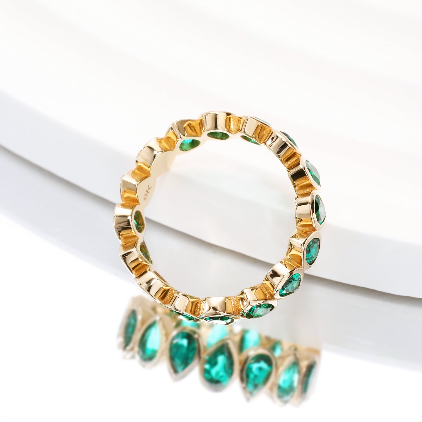 Bezel set Lab Grown Emerald 3x5 pear shaped eternity band ring in gold