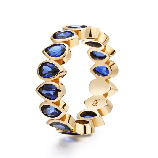 Bezel set Lab Grown Sapphire Royal Blue 3x5 pear shaped eternity band ring in gold