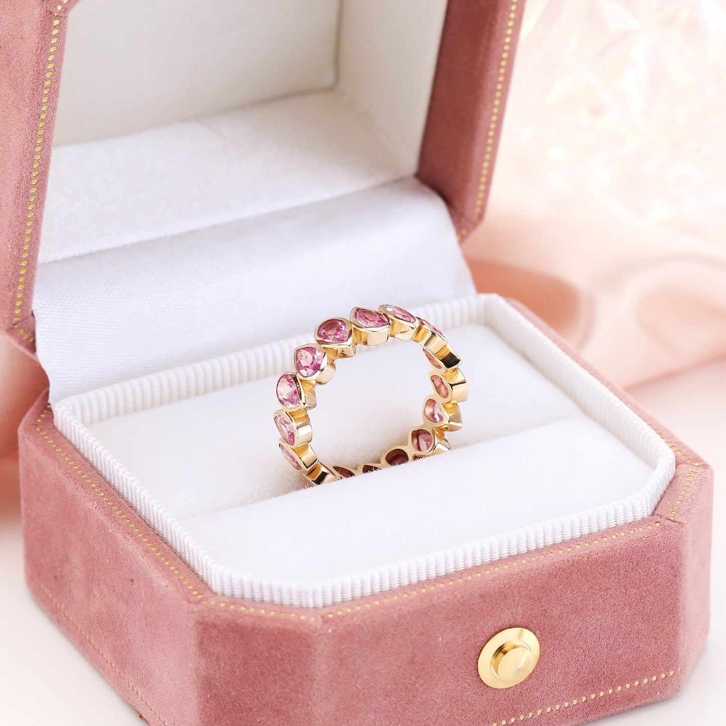 Bezel set Lab Grown Pink Sapphire 3x5 pear shaped eternity band ring in gold